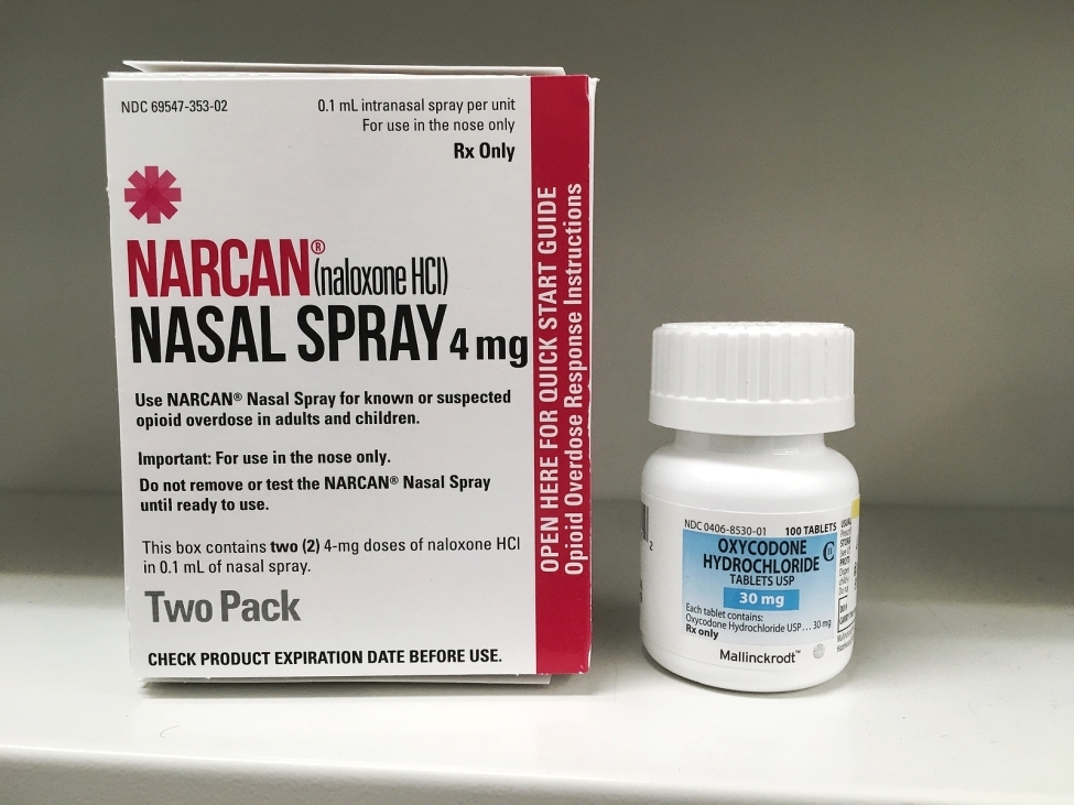 A box of Narcan and a bottle of Opioids to symbolize opioid overdose prevention.