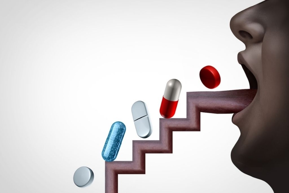 pills going up a tongue shaped as stairs to describe substance abuse concept as over-prescribed medication
